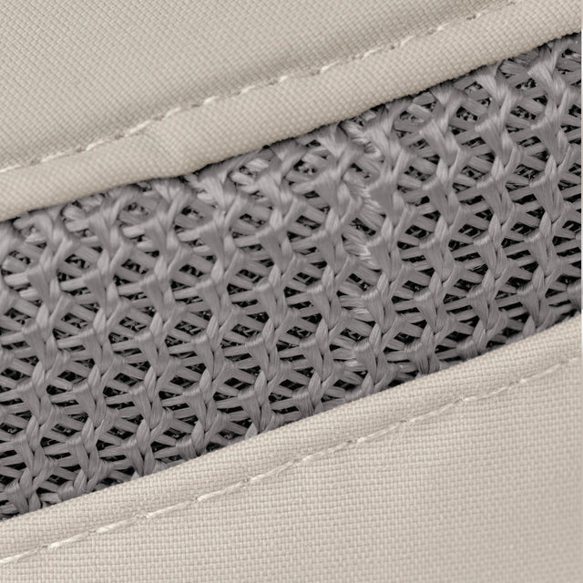Close-up of a woven mesh material in gray, bordered by light beige fabric with visible stitching.