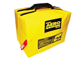 Bright yellow emergency bag labeled "Revere Aero Compact Liferaft" with black handles and a red safety tag, signifying preparedness and safety.