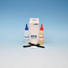 A G5 adhesive kit with two squeeze bottles (one blue-capped, one red-capped), a white box, and two black applicator tools on a blue gradient background.