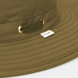 Close-up of a green bucket hat with a brand logo on a white background