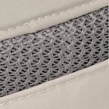 Close-up of a woven mesh material in gray, bordered by light beige fabric with visible stitching.