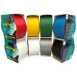 Six rolls of Duck Tape in different colors (red, yellow, green, blue, white, gray, and black) displayed inside their retail packaging on a solid white background.